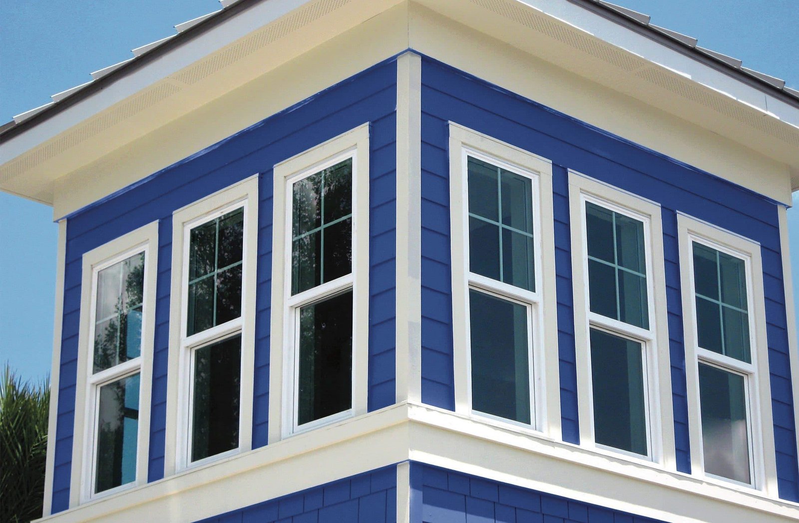 New white windows on a blue home exterior